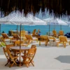 Restaurant terrace with tables and umbrellas at Capri Beach Club