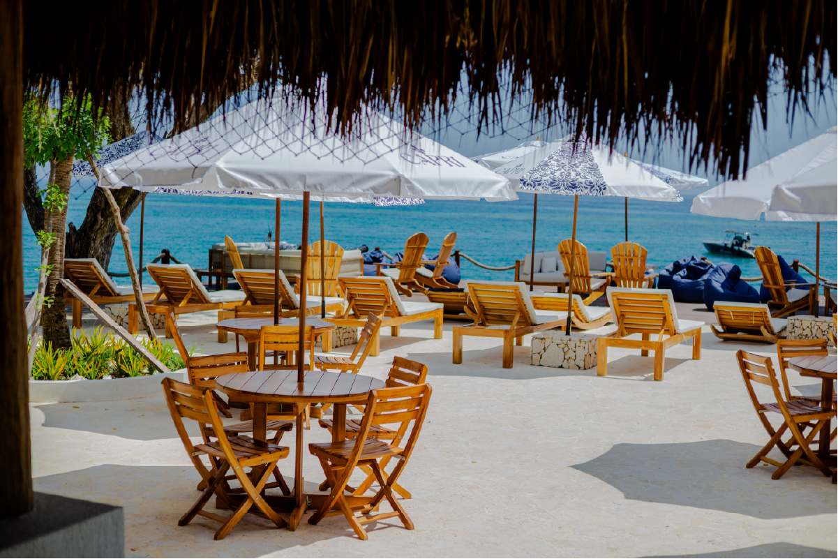Restaurant terrace with tables and umbrellas at Capri Beach Club