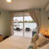 Bedroom with sea view and private deck at Fragata Island House, Rosario Islands