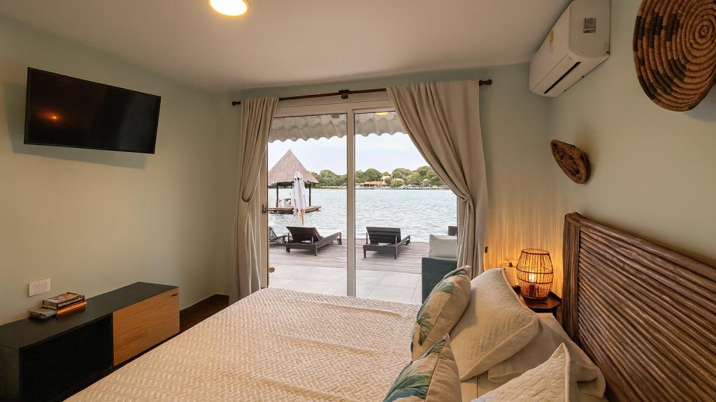 Bedroom with sea view and private deck at Fragata Island House, Rosario Islands