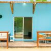 Blue exterior terrace with seating at Fragata Island House