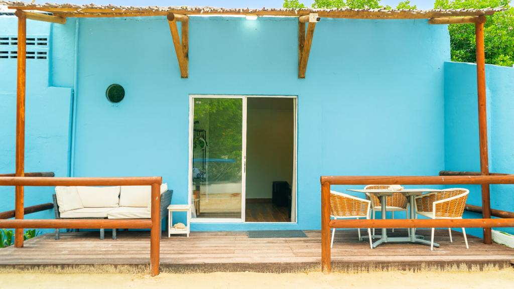 Blue exterior terrace with seating at Fragata Island House
