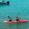 Guests kayaking on turquoise water at Ibbiza Island, Rosario Islands