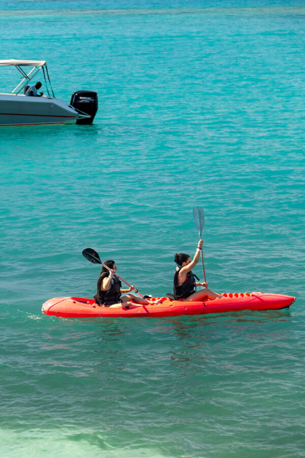 Guests kayaking on turquoise water at Ibbiza Island, Rosario Islands