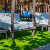 VIP zone with cushioned daybeds under palm shade at Luxury Beach Club