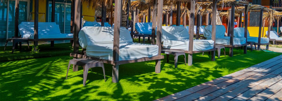 VIP zone with cushioned daybeds under palm shade at Luxury Beach Club
