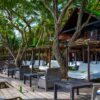 Shaded lounge area under trees at Luxury Beach Club, Rosario Islands