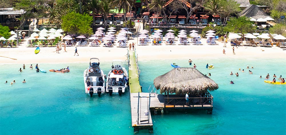 Aerial view of the pier, boats and turquoise water at Luxury Beach Club