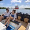 Couple on the stern seats of the Nederucho boat with twin outboard engines, Cartagena
