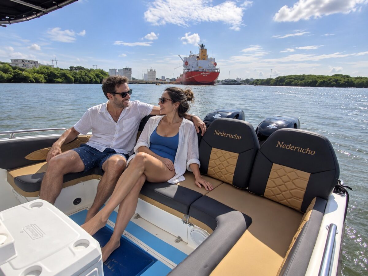 Couple on the stern seats of the Nederucho boat with twin outboard engines, Cartagena