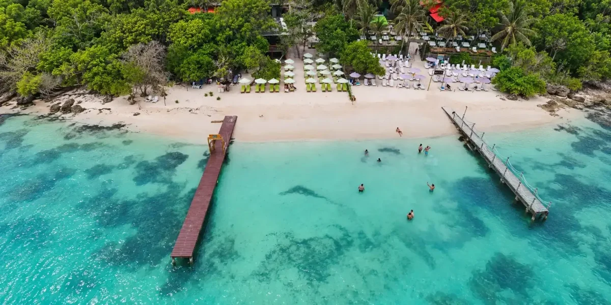 Aerial view of the beach and pier at Mantas Beach Club