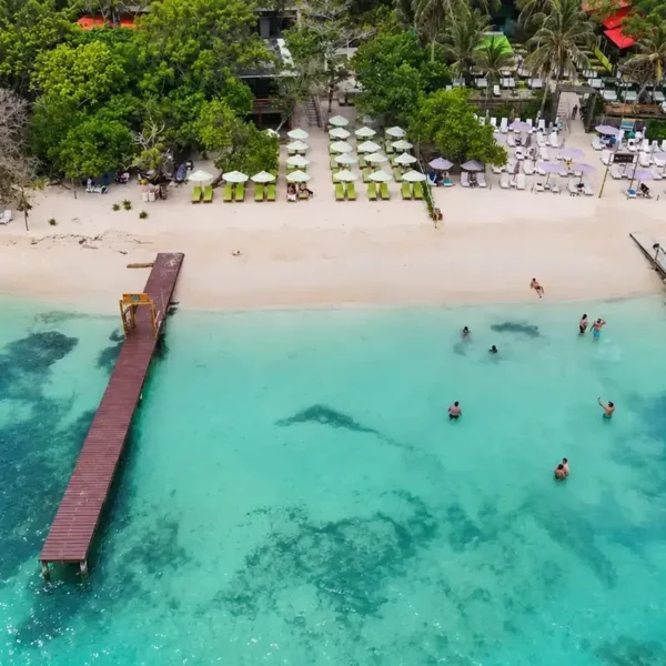 Aerial view of the beach and pier at Mantas Beach Club