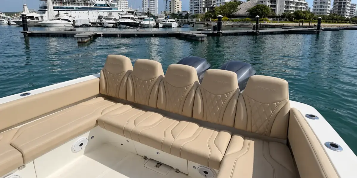 Rear bench and twin engines of the Altamare boat at the marina