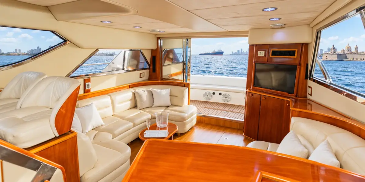Air-conditioned salon with leather sofas and TV on the Bellajava yacht