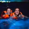 Couple in the bioluminescent plankton at night