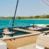 Relaxing on the bow nets of the Bonavida catamaran