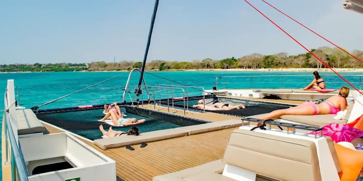 Relaxing on the bow nets of the Bonavida catamaran