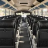 Aisle, seat rows and air conditioning inside the coach transfer bus