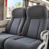 Padded reclining seats inside the 24-guest Coaster bus in Cartagena