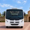 Front view of the 24-guest Coaster bus in front of the Clock Tower, Cartagena