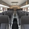 Rows of seats and air conditioning inside the Coaster transfer bus