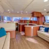 Salon with sofas and kitchen on the Cork Trick yacht