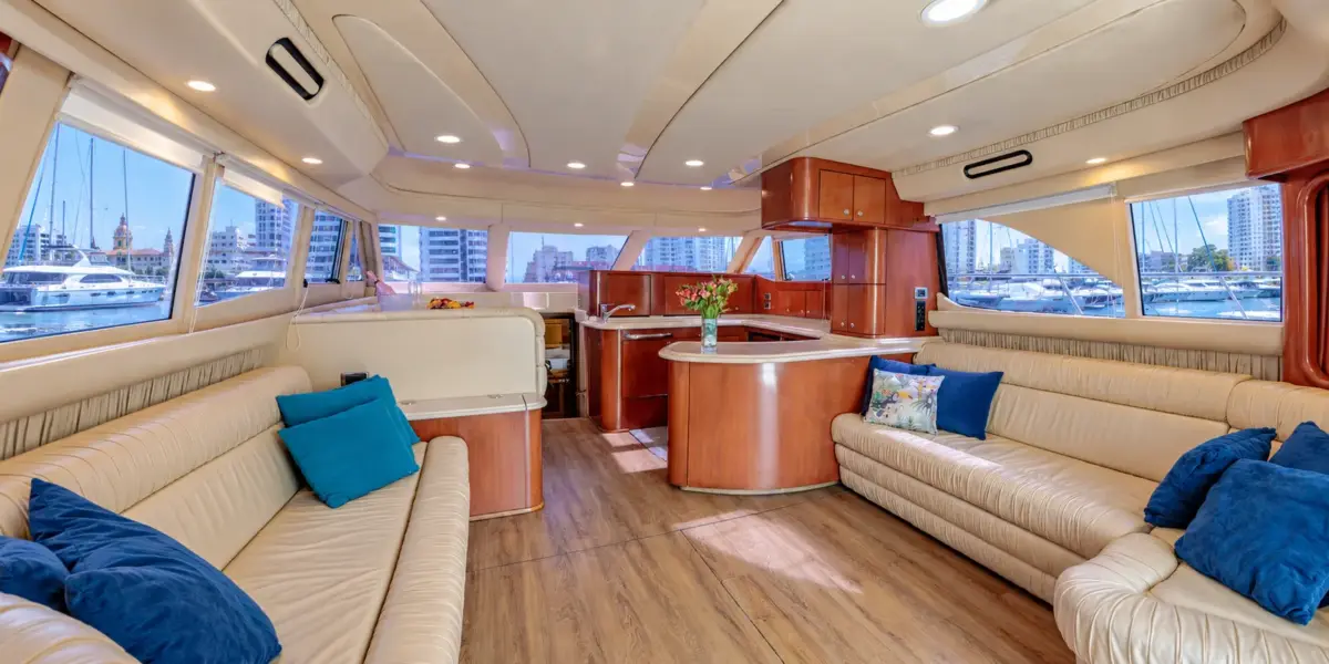 Salon with sofas and kitchen on the Cork Trick yacht