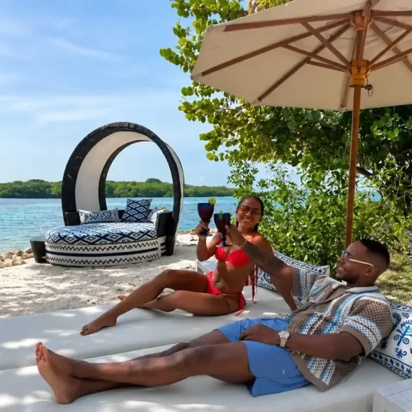Couple relaxing on a beach bed at Dharma Beach Club