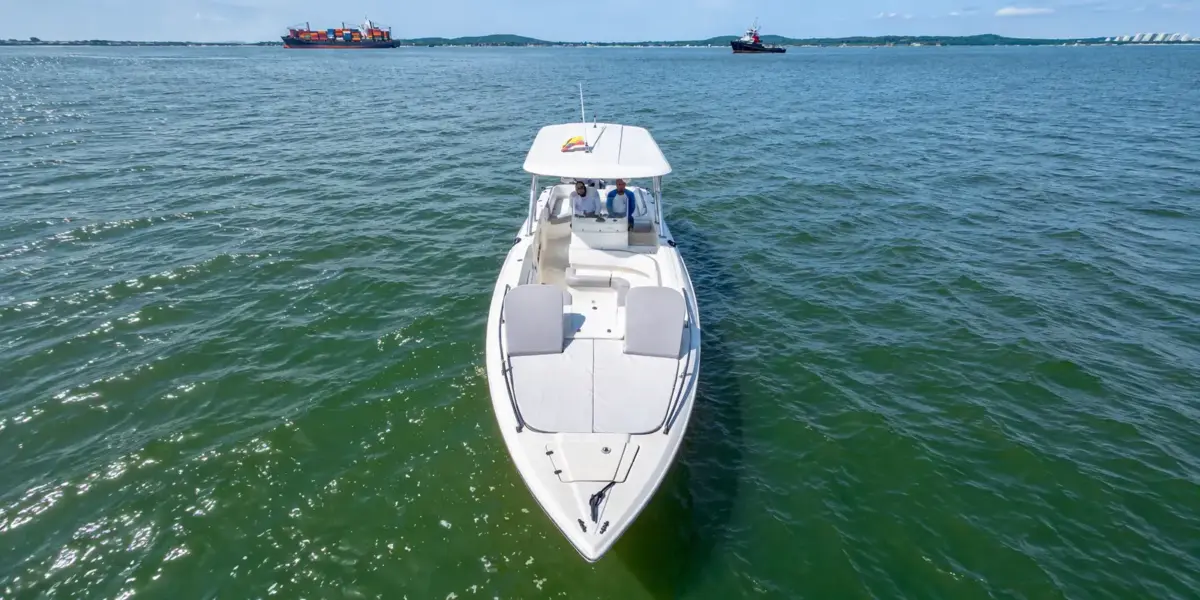 Interceptor private boat in Cartagena Bay with ships in the background