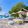 Lounge area and cabana by the sea at Dharma Beach Club