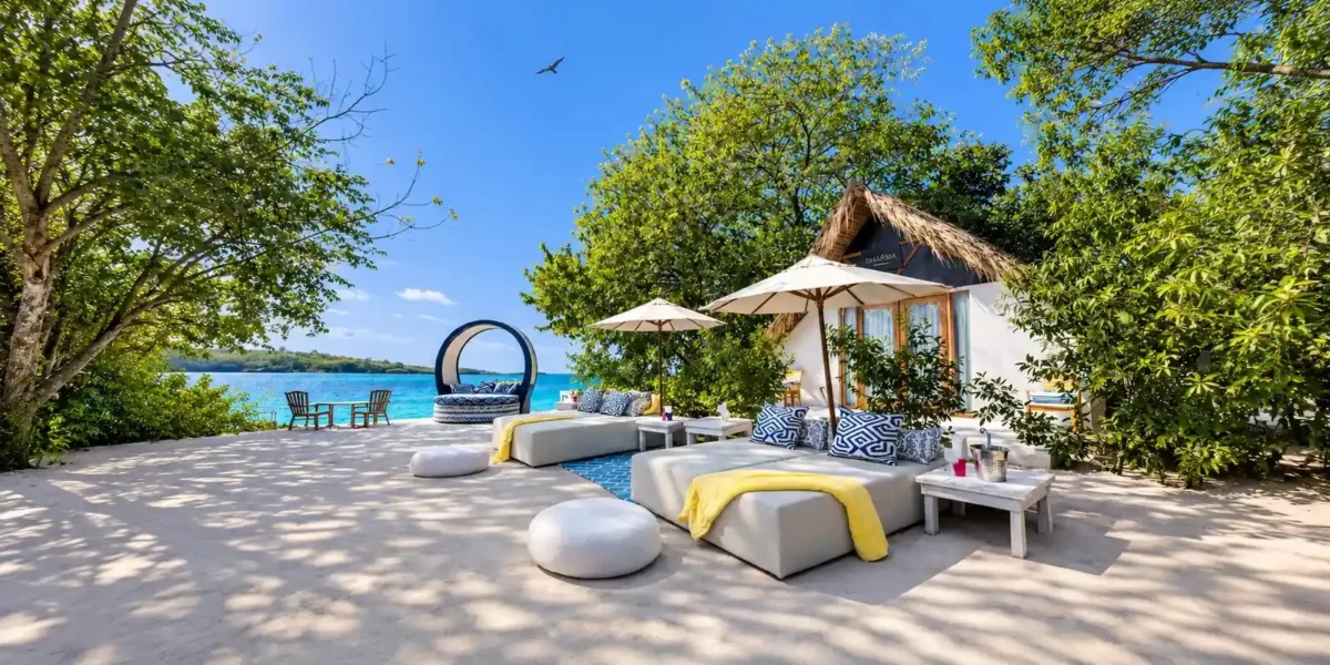 Lounge area and cabana by the sea at Dharma Beach Club