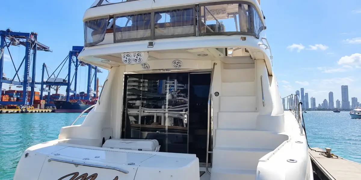 Stern of the Mama's yacht with salon doors and flybridge stairs