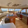 Dining table and full kitchen in the air-conditioned salon of the Mama's yacht