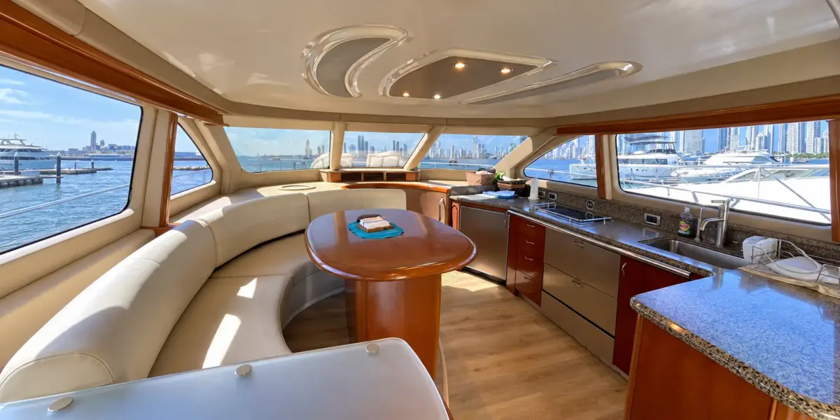 Dining table and full kitchen in the air-conditioned salon of the Mama's yacht