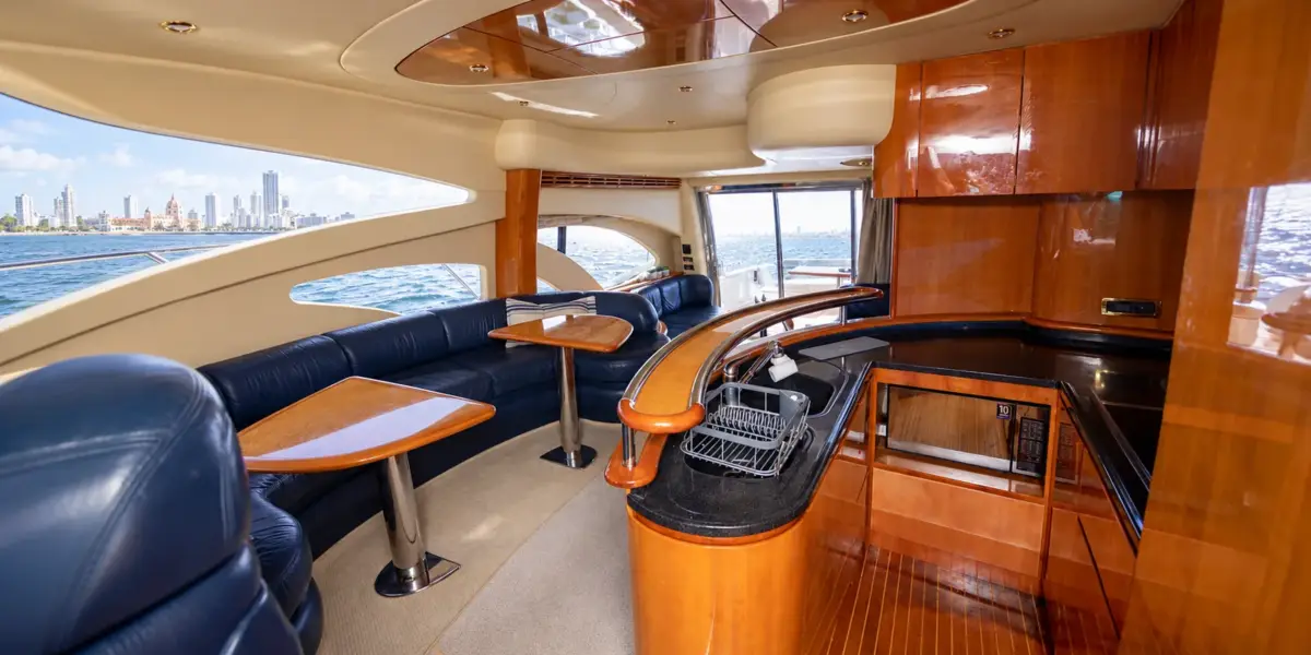 Salon with navy leather sofas and galley on the My Toy yacht