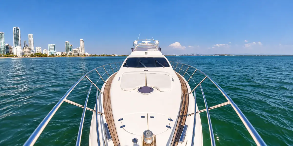 Bow of the My Toy yacht facing the Cartagena skyline