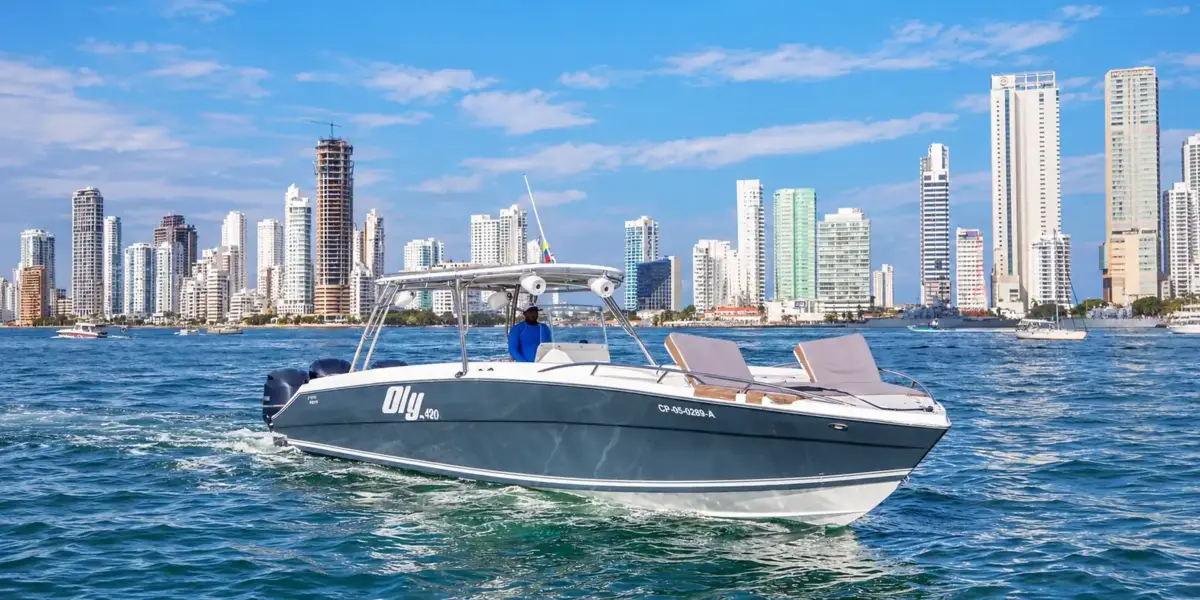 Oly 420 private boat cruising past the Bocagrande towers