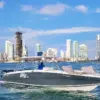 Oly 420 42 ft private boat cruising with reclining sunbeds in front of the Cartagena skyline