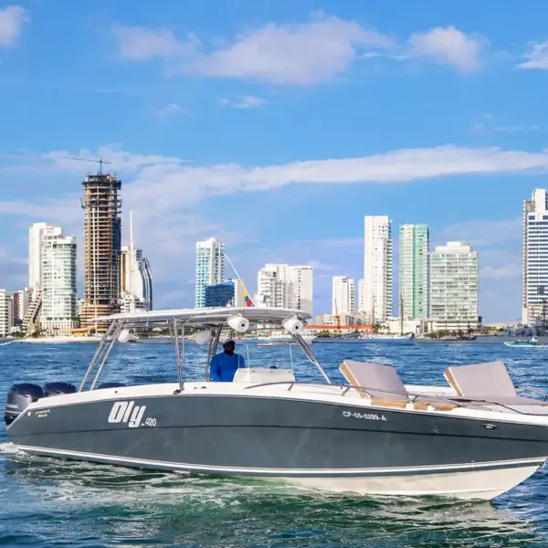 Oly 420 42 ft private boat cruising with reclining sunbeds in front of the Cartagena skyline