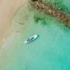 Paddleboarding in turquoise water at Paue Beach Club