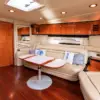 Indoor lounge with kitchen and TV on the Palladium yacht