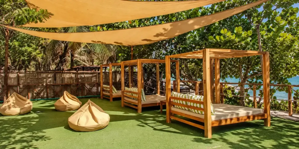 Shaded lounge beds at Mantas Beach Club