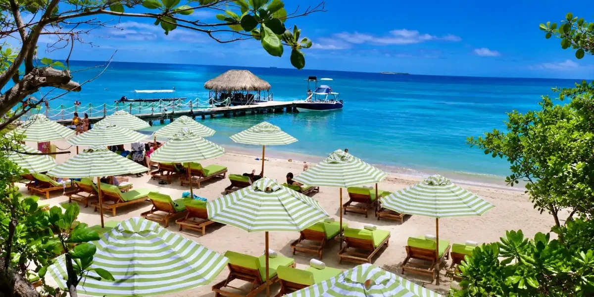Striped umbrellas and pier at Mantas Beach Club, Rosario Islands