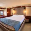 Master cabin with double bed and TV on the Suerte yacht