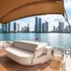 Shaded aft deck with sun pad and Cartagena skyline on the Suerte yacht