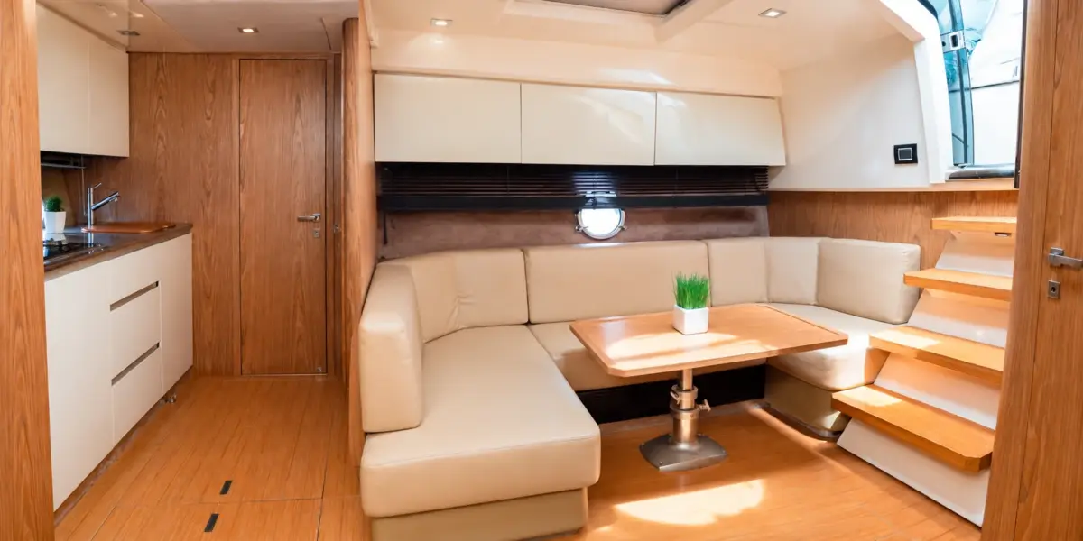 Air-conditioned indoor lounge with sofa and galley on the Zetta yacht